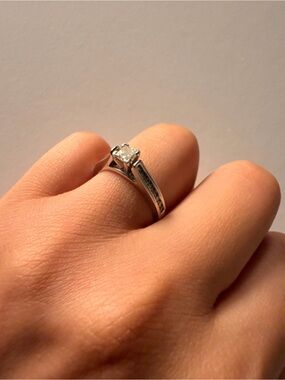 14k white gold with a 1 carat diamond princess cut ring.